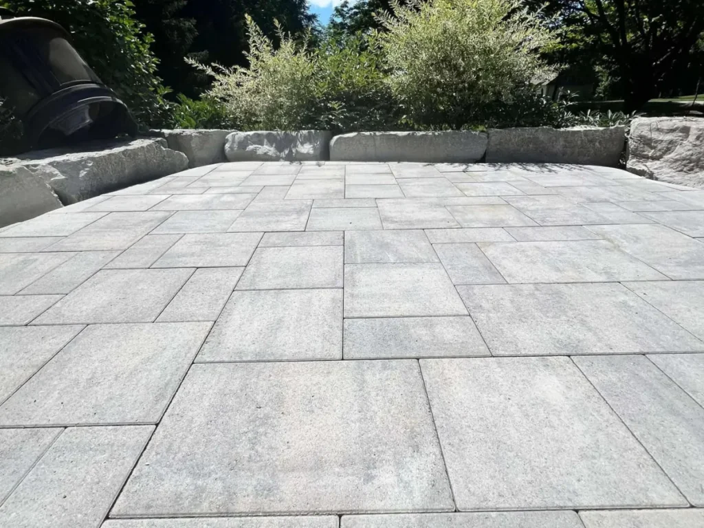 Custom backyard patio with armour stone and pavers in Barrie