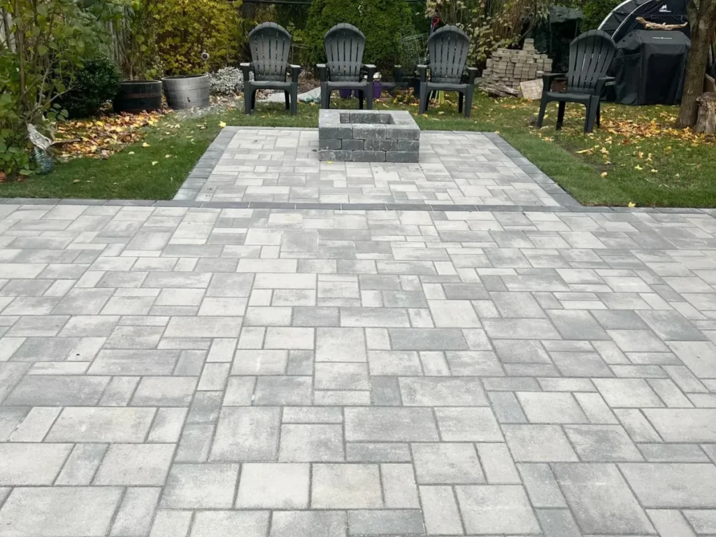 Backyard stone firepit and patio installation by Big G Landscapes