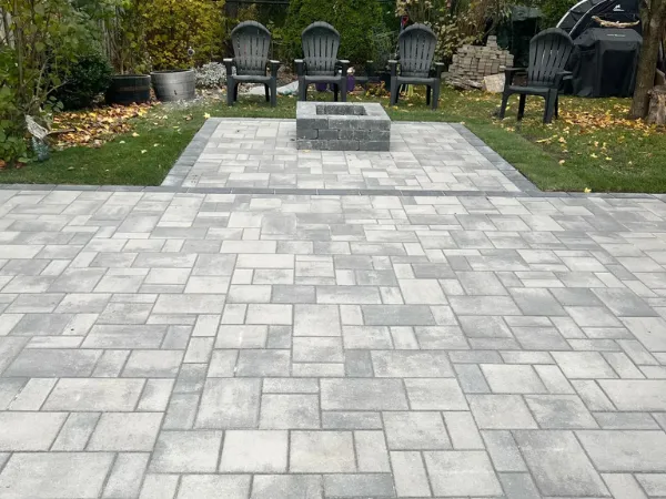 Backyard stone firepit and patio installation by Big G Landscapes